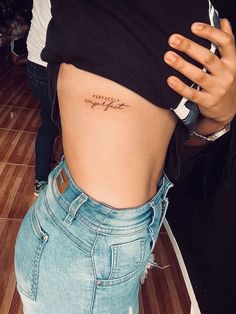 a woman's lower back tattoo with the words, i love you in cursive writing