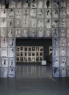 an art gallery with many black and white pictures on the wall