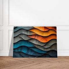 an abstract painting on the wall in a room with wood flooring and white walls