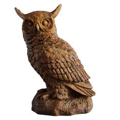 an owl statue sitting on top of a wooden stump in front of a white background