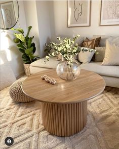 a living room filled with furniture and flowers on top of a coffee table in front of a couch