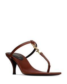 Saint Laurent Cassandra Sandals in Smooth Leather Designer T-strap Sandals For Formal Occasions, Designer Brown Evening Sandals, Designer Brown Sandals For Evening, Luxury Formal T-strap Sandals For Summer, Luxury Brown Sandals With Heel Loop, Luxury T-strap Sandals With Single Toe Strap, Luxury T-strap Sandals With Single Toe Strap For Evening, Luxury High Heel T-strap Sandals, Luxury Evening T-strap Sandals With Single Toe Strap