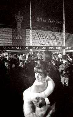 black and white photograph of woman in fur coat at awards