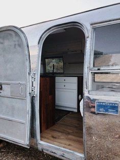 an old trailer with the door open