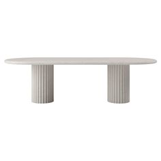 a white table with two columns on the top and one column at the base, in front of a white background