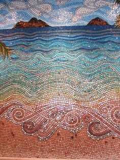 a mosaic tile wall with palm trees and the ocean