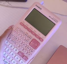 a pink calculator sitting on top of a table