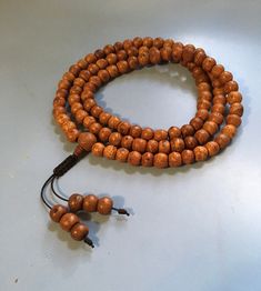 Spiritual Wooden Beads Necklace For Puja, Adjustable Hand Knotted Mala For Meditation, Adjustable Spiritual Hand-strung Mala, Adjustable Spiritual Mala With 8mm Beads, Brown Wooden Beads Jewelry For Puja, Hand Knotted Adjustable Spiritual Beads, Adjustable Brown Mala For Healing, Adjustable Hand-strung Spiritual Mala, Adjustable Hand Knotted Beads For Meditation