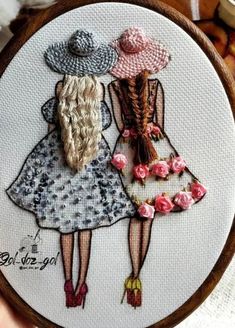 two girls with hats on their heads are holding each other's back in this hand embroidery pattern