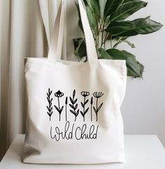 a white tote bag with the words wild child printed on it