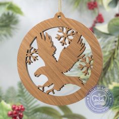 a wooden ornament with an eagle and snowflakes in the shape of a circle