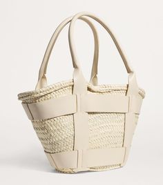 Find DEMELLIER Raffia Santorini Tote Bag on Editorialist. The Demellier Santorini tote bag is crafted from natural palm leaves and is handwoven in Morocco. The bag features a woven design and top handles. It embodies the brand's commitment to sustainable and artisanal practices. Boots Knee, Shoes Heels Pumps, Trainer Boots, Luggage Accessories, Trending Gifts, Boot Sandals, Giorgio Armani, Luggage Bags, Santorini