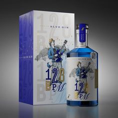 a bottle of blue gin next to a box