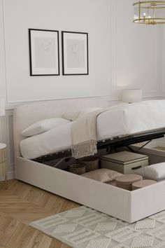 a white bed sitting on top of a wooden floor