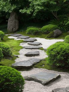 a stone path in the middle of a garden