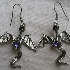 This Is A Set Of Dragon Earrings With French Style Earwires. Made Of Pewter, Each Dragon Holds A Round Purple Set. Open Wings. 3d: Has Full Back Side Of Dragon. Made In Usa By Real Metal. Each Dragon Is 1 3/4 Inches Long And 1 1/2 Inches Wide. Total Length With Earwire Is 2 1/4 Inches. Lovely Detail. Great For Dragon Fans And Fantasy Lovers. Fantasy Metal Earrings With Ear Wire, Handmade Fantasy Metal Earrings, Handmade Metal Fantasy Earrings, Fantasy Metal Earrings For Jewelry Making, Adjustable Wire Wrapped Fantasy Earrings, Adjustable Fantasy Earrings For Gifts, Adjustable Fantasy Earrings For Gift, Adjustable Gothic Earrings, Adjustable Gothic Earrings For Gift