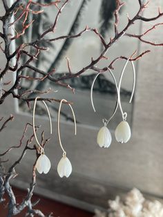 "Hawaiian Mother of Pearl Pikake and 14K Gold Filled or 925 Silver dangle earrings Super popular bridesmaid and wedding gifts for friends and family. *1.75\" long *Pierced ear - simple V hook earrings *Lightweight: 2 ounces *Material: Natural White mother of pearl Pikake and 925 Sterling Silver hook or 14K Gold filled hook The White Mother of Pearl is iridescent and reflects light when you move it around. Really high quality. Handmade with Aloha by me. Mahalo and enjoy!"