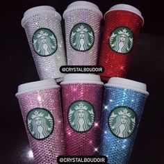 four starbucks cups with different colors and designs are shown in this image, the cup has glitter