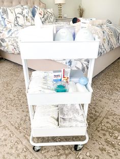 a white cart with items on it in a bedroom