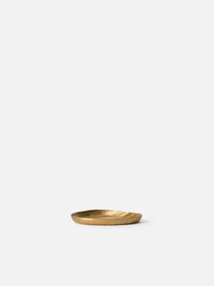 a gold plate sitting on top of a white table