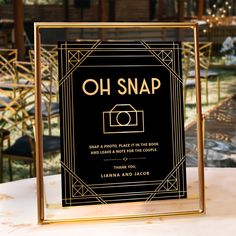 a black and gold wedding sign with the words oh snap written in gold on it