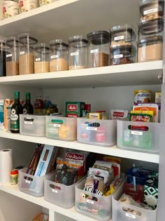 an organized pantry with plastic containers, food and other items on shelving unit shelves