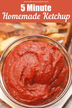 a bowl filled with homemade ketchup sitting on top of a table