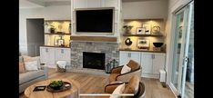 a living room filled with furniture and a flat screen tv mounted on the wall above a fireplace