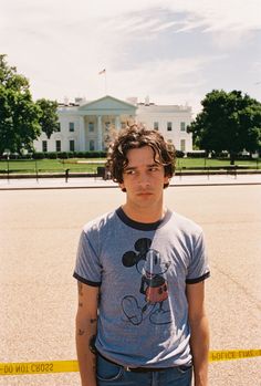 a young man standing in front of the white house