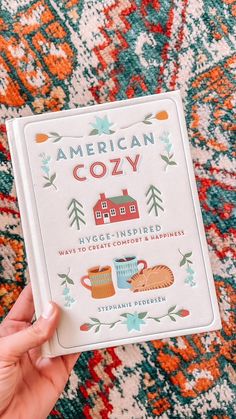 the american cozy book is being held up