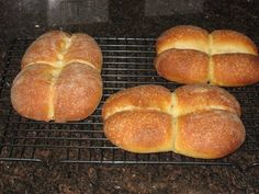 four loaves of bread sitting on a cooling rack