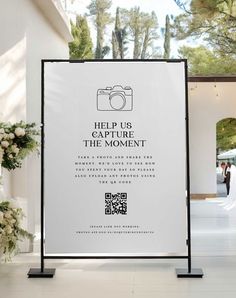 a sign that says help us capture the moment, take a photo and share it with someone else