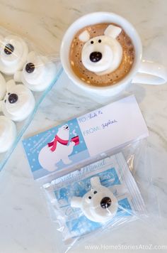 a cup of hot chocolate with marshmallows in the shape of polar bears