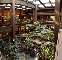 the inside of a building with lots of plants