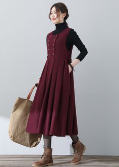 Winter A-line Dress With Button Closure, Knee-length Buttoned Midi Dress For Winter, Winter Knee-length Midi Dress With Buttons, Winter A-line Midi Dress With Buttons, Sleeveless Dresses With Pockets For Fall, Sleeveless Pinafore Dress For Fall, Winter Cotton Midi Dress For Work, Cotton Sleeveless Knee-length Dress With Buttons, Winter Workwear Cotton Midi Dress