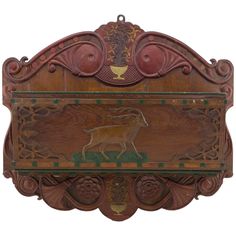 a wooden plaque with an animal on it