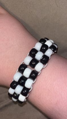 a person wearing a black and white bracelet