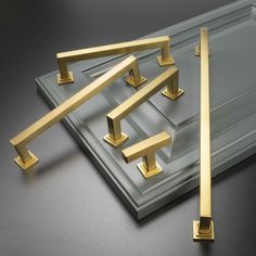 an image of some gold handles on a black table with grey background and gray surface