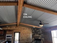 a kitchen with a ceiling made out of metal sheets and wood planks that reads tin ceiling