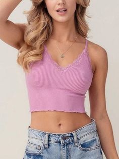 "Get ready to elevate your wardrobe with this must-have ribbed crop cami.  The delicate lace trim adds a touch of femininity, while the adjustable straps ensure a perfect fit.  Perfect for layering or wearing alone, this tank top is made with a soft, stretchy knit fabric that will keep you comfortable all day. This versatile crop top is perfect for all seasons and will be a timeless addition to your wardrobe. Knit V neck line Bralette features Seamless and Super Soft Stretchy Fabrication and is Layering Tank Tops, Layering Tanks, Cropped Cami, Stretchy Fabric, All Seasons, Bralette, Lace Trim, Knit Fabric, Knitted Fabric