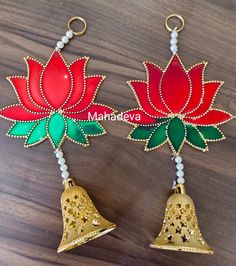 two red and green bells with beads hanging from them