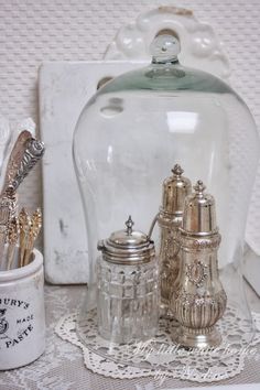 there is a glass jar with silver items in it