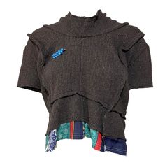 2014 'Comme des Garçons' brown knitted top with short sleeves and patchwork construction. There is a blue metal pin on the front with little bells. The bottom has a patchwork of different patterned silk fabrics. The knit is made from 66% wool 29% polyester 3% nylon 2% acrylic and the fabric at the bottom is made of 100% silk.  Size: Labeled as a size Medium and I'd say would fits true to size although would also fit a smaller size with a looser fit. For reference, the mannequin is a size XS. Ver Brown Knit Patchwork Top, Silk Fabrics, Knitted Top, Pullover Sweater Women, Metal Pins, Comme Des Garcons, Women Pullover, Jumpers For Women, Silk Fabric