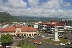 an aerial view of a city with tall buildings and cars parked in the parking lot