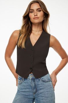 Meet Millie- the woven button-up vest - Designed with a tailored fit with a stretch to flatter your form. Features - Sleeveless - V-neckline - Four Button detail - Back vent Size & Fit - Fitted Materials & Care - 40% Polyester, 30% Recycled Polyester, 23% Rayon, 7% Spandex - Machine wash, cold - Imported Button Vest, Vest Designs, Blazer Vest, Button Detail, Button Up, Blazer, Wardrobe, Clothes