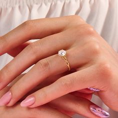 a woman's hand with pink manicures and a diamond ring