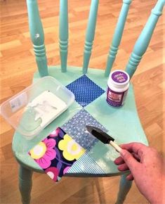 someone is painting a chair with blue paint