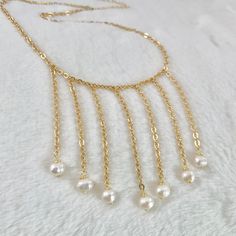 Waterfall necklace, Modern pearl necklace, classic pearl necklace, freshwater white pearl necklace, bridesmaid gift ideas, stylish necklace. Jewelry is one of the ways people identify themselves to others. For this reason consider to wear this stylish Cascade necklace as a way to expresses your captivating personality. Perfect to wear on your special day! For sure this delicate necklace will enhance your natural beauty! 💕 ITEM DESCRIPTION: Total length: 15 inches. The length of the necklace ref Multi-strand Pearl Chain Necklace As Gift, Multi-strand Pearl Chain Necklace For Gift, Wedding Pearl Necklace With Multi-strand Pearl Chain, Elegant Shell-shaped Pearl Chain Necklace, Modern Pearl Necklace, Multi-strand Pearl White Pearl Necklace For Party, Waterfall Necklace, Cascade Necklace, Classic Pearl Necklace