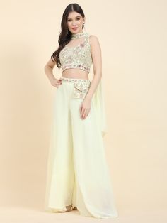 Introducing our stunning light yellow georgette crop top, adorned with heavy mirror work and intricate embroidery, designed to add a touch of elegance and charm to your wardrobe. This beautifully crafted crop top showcases meticulous attention to detail, with each mirror and embroidery stitch enhancing its visual appeal. The soft georgette fabric ensures a comfortable and luxurious fit, making it a perfect choice for any special occasion.
Paired with this exquisite crop top are matching georgett Crop Top With Palazzo, Georgette Crop Top, Top With Palazzo, Yellow Mirror, Engagement Gown, Lehenga Crop Top, Yellow Mirrors, Lehenga Choli Wedding, Floral Lehenga