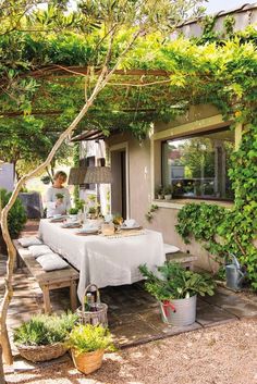 an outdoor dining area with table and chairs